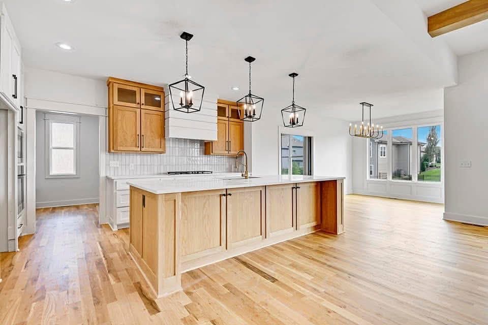 Modern kitchen with pendant lighting and recessed lights installed by Prestige Electric in Kansas City